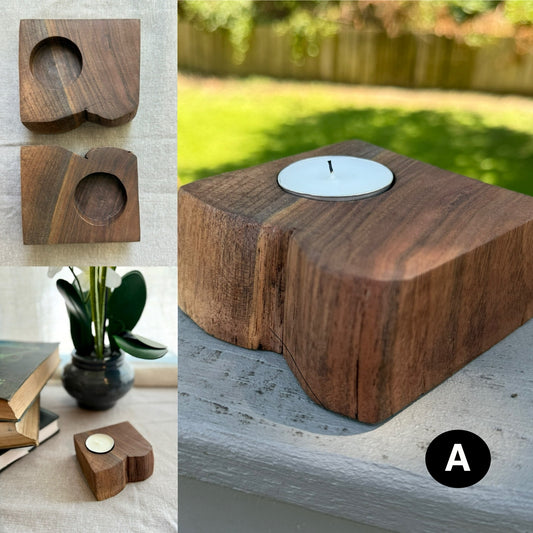A set of two handcrafted walnut tea light candle holders labeled A, each with a similar shape and rich grain pattern. Shown styled with books, plants, and natural light.