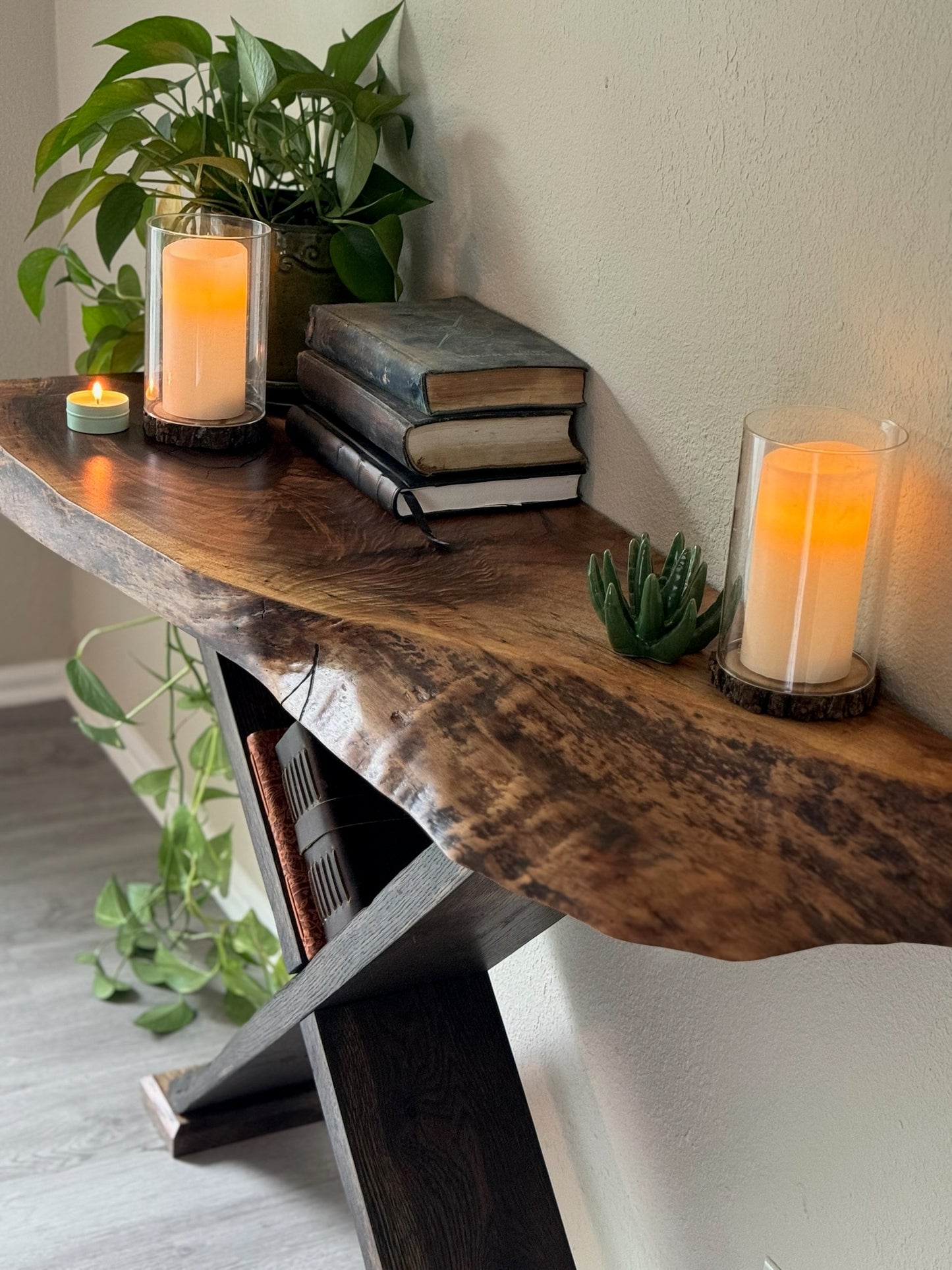 zoomed in shot of live edge entryway table with visible grain and organic shape on black x legs
