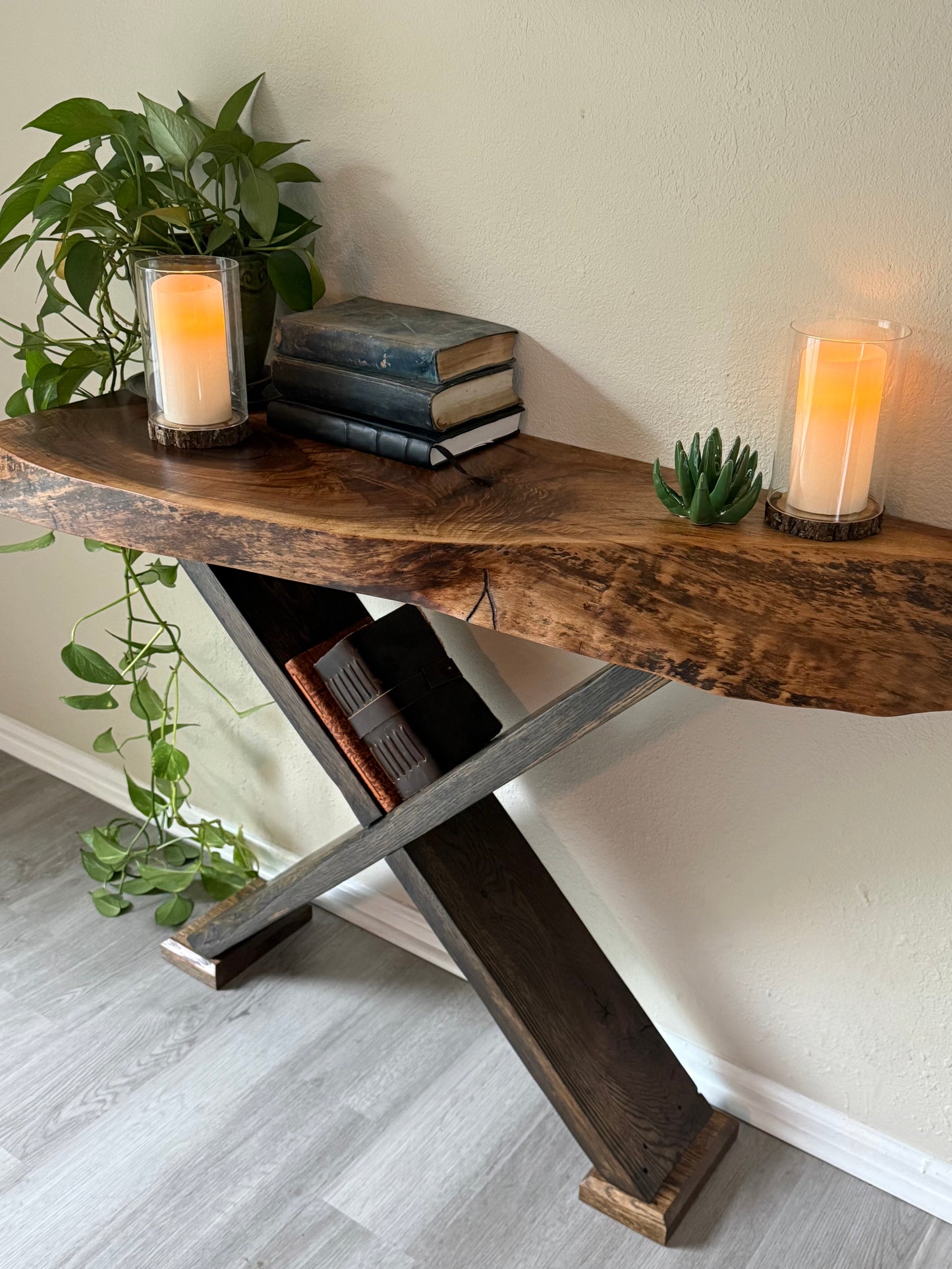 organic natural walnut slab console table styled with trailing greenery, books and candles