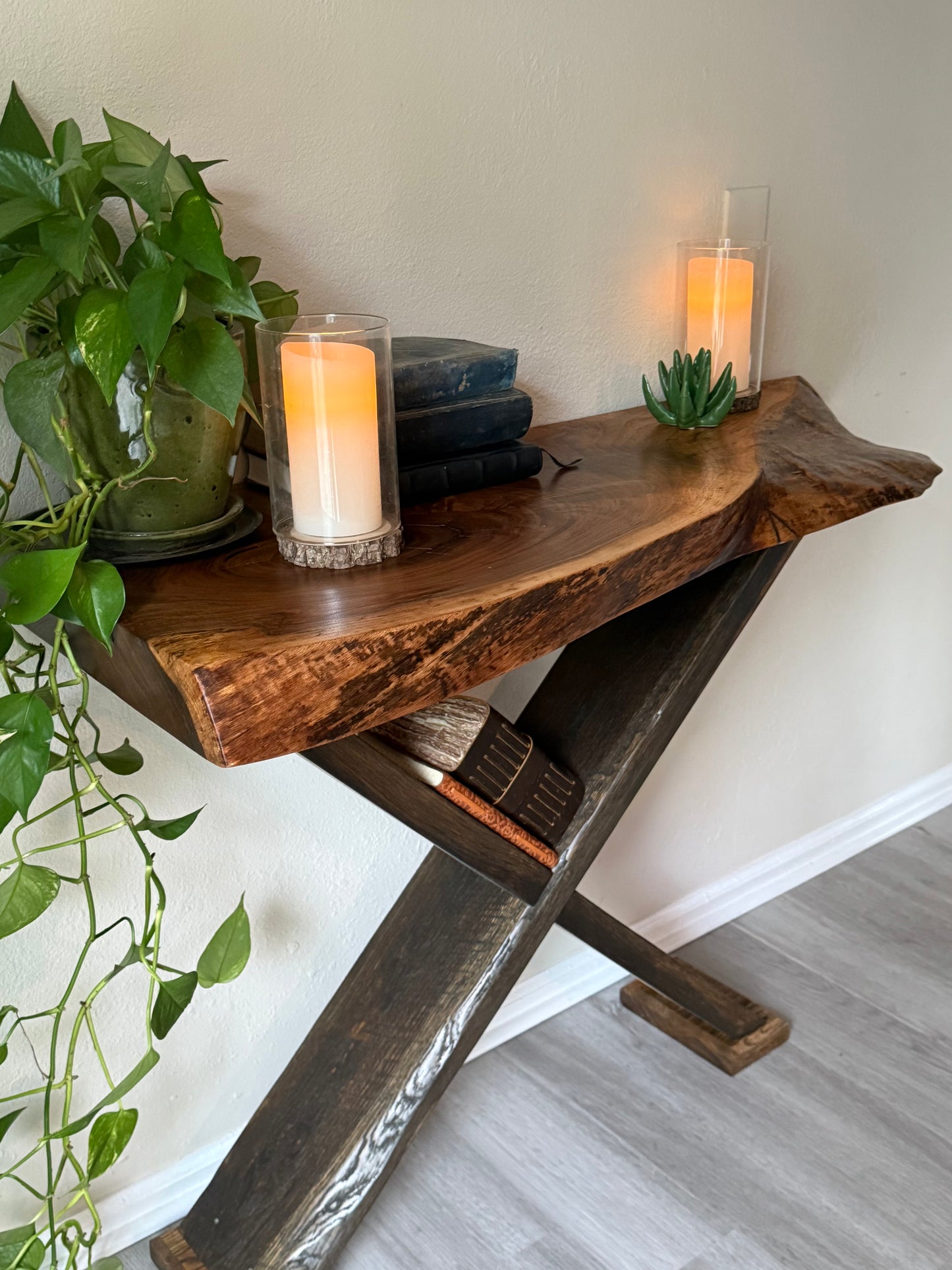 close-up of live edge walnut entry table with visible wood grain and organic shape, on oak x legs