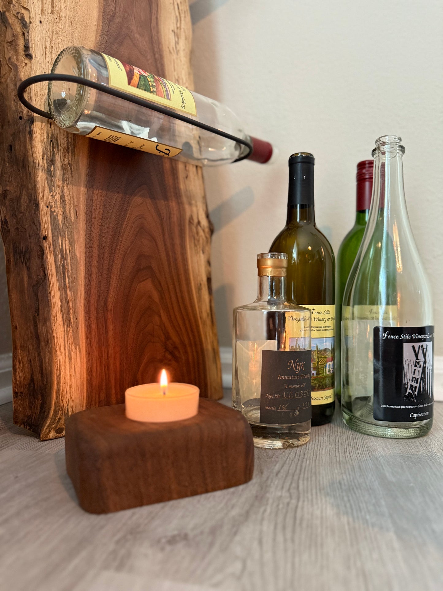 Handmade walnut wine rack styled with flowers and candle for home décor inspiration