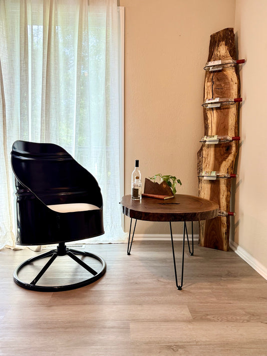 Cozy home setting with wine rack, live edge coffee table, candle, and plants.