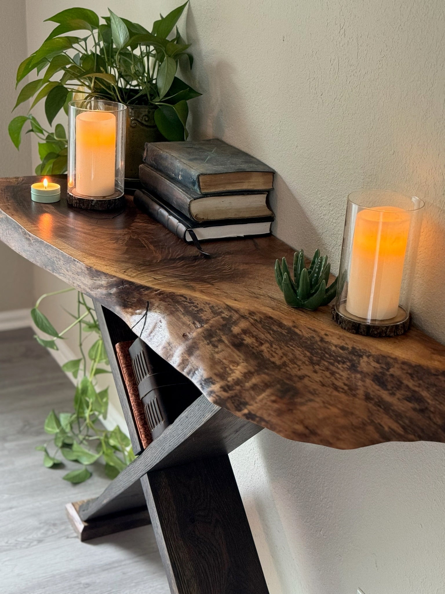 zoomed in shot of live edge entryway table with visible grain and organic shape on black x legs