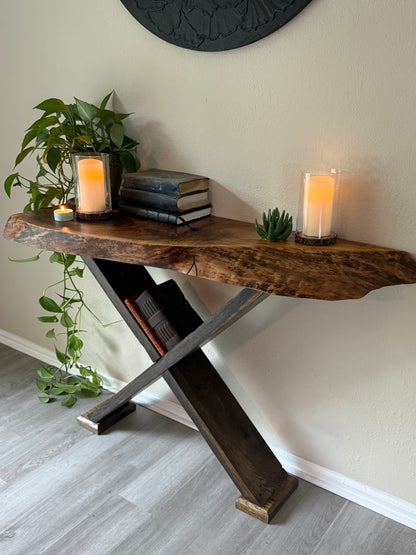 live edge wood console table styled with trailing greenery, vintage books and candles