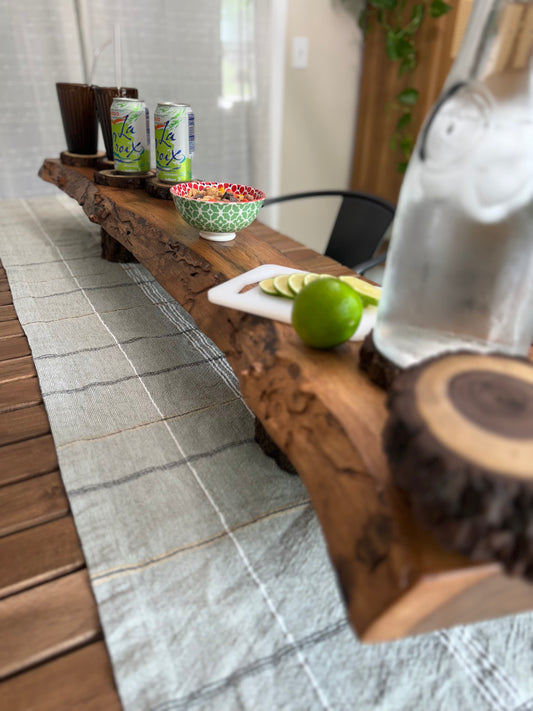 live edge charcuterie board styled with fruit and drinks 